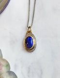 Black opal, gold, and silver pendant